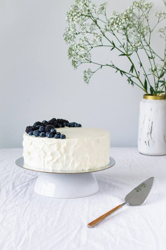 White cake with berries on top